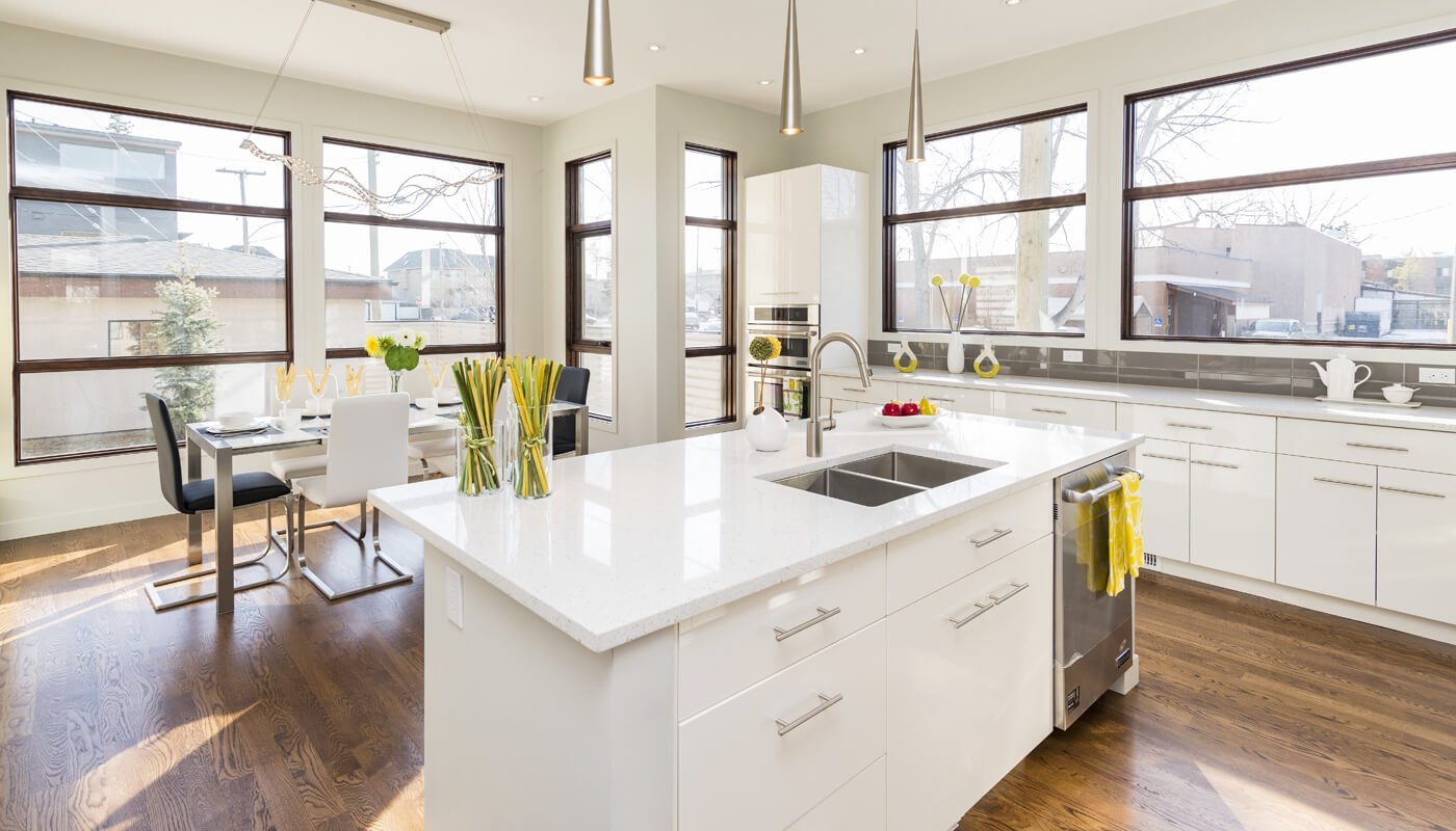 Elegant kitchen interior with hardwood floors, pendant lighting, and minimalistic decor